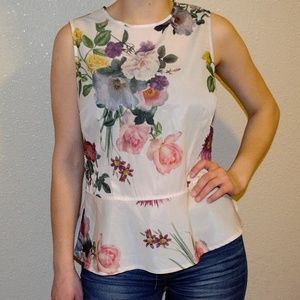 Sleeveless Floral Peplum Shirt .